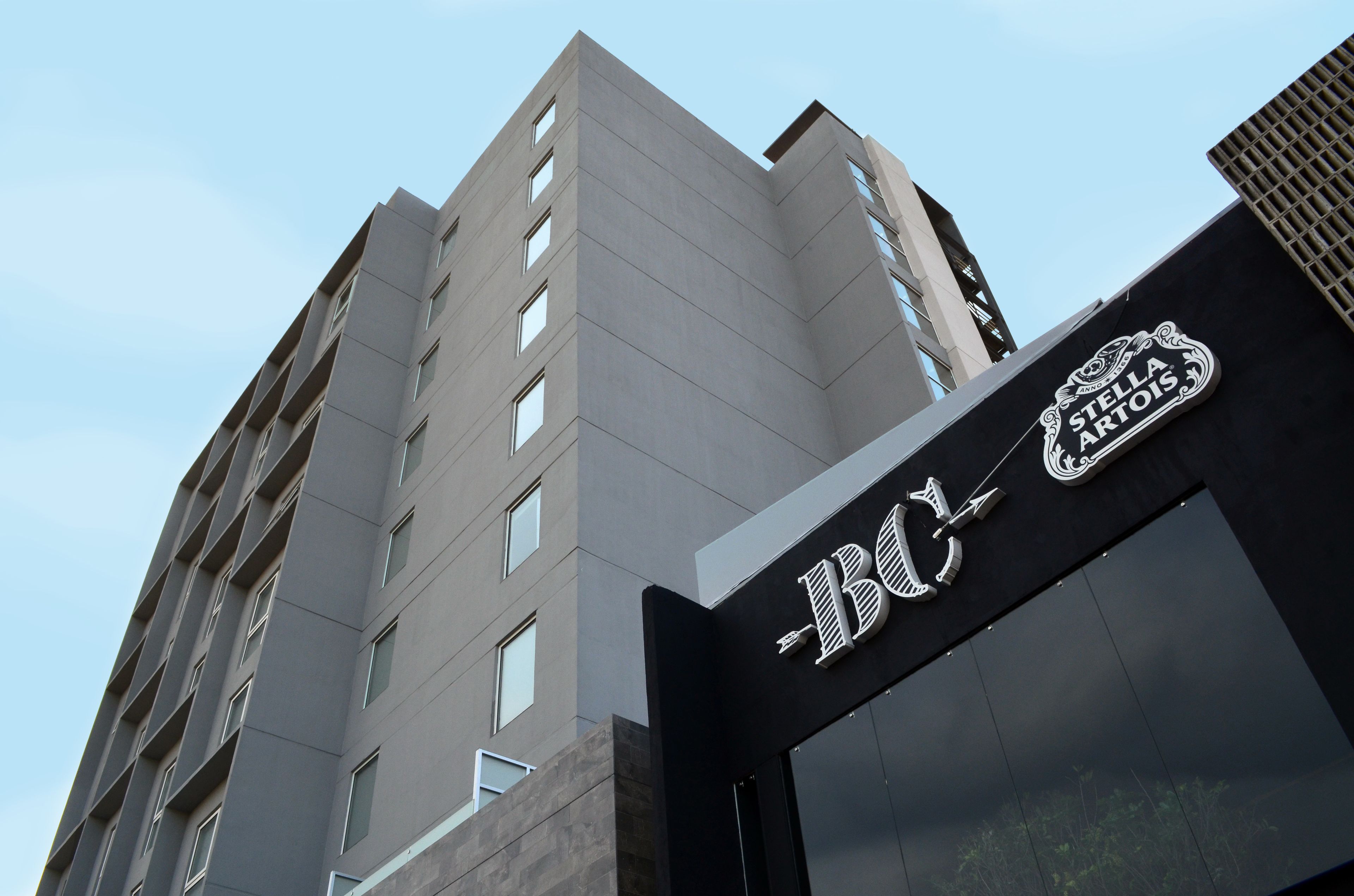A modern building with a sign reading "BC" and "STELLA ARTOIS".