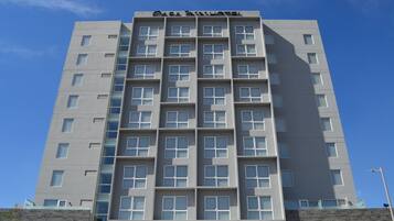 A multi-story hotel with a modern design, featuring a prominent name at the top.