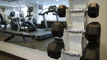 A gym with exercise equipment, including dumbbells and treadmills.