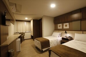 Luxury Triple Room | Minibar, in-room safe, desk, laptop workspace