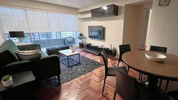 Business Apartment, 4 Bedrooms | Living area | 32-inch LED TV with cable channels, TV