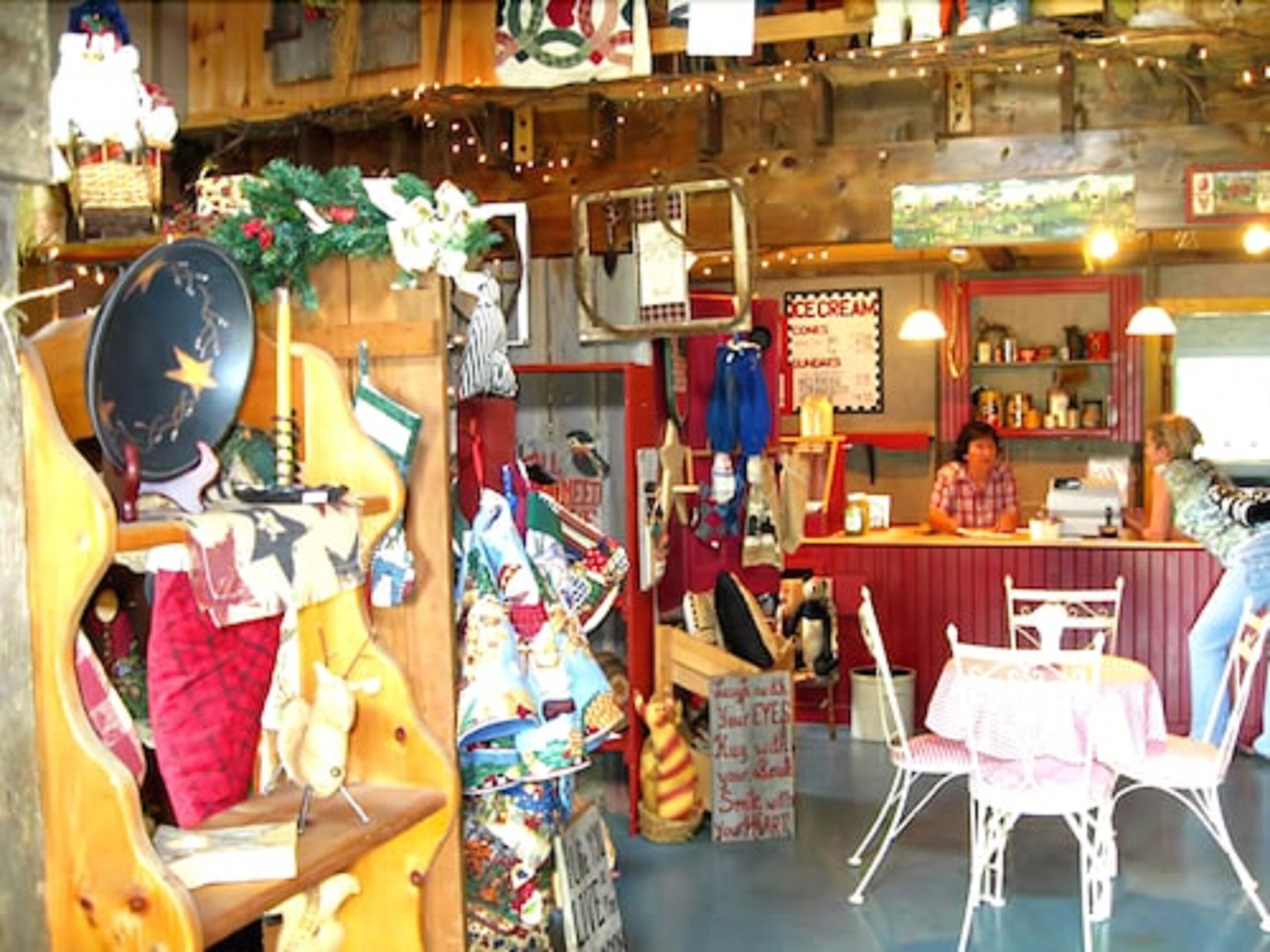 A cozy, rustic interior with a bar area, wooden furniture, and various decorations.