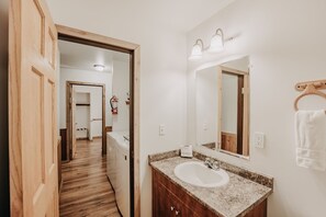 Comfortable hotel room with a wardrobe, sink, and mirror.