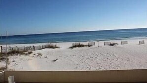 A beach with a clear sky and calm sea.
