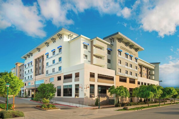 Experience the Courtyard's sleek, multi-story design with expansive balconies and beautifully landscaped surroundings.