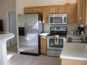 Standard Apartment, 3 Bedrooms | Private kitchen | Fridge, microwave, stovetop, dishwasher