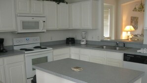 A modern kitchen with white cabinetry, a built-in microwave, stove, and dishwasher. - Lovely Home Perfect for a Family (Haines City)