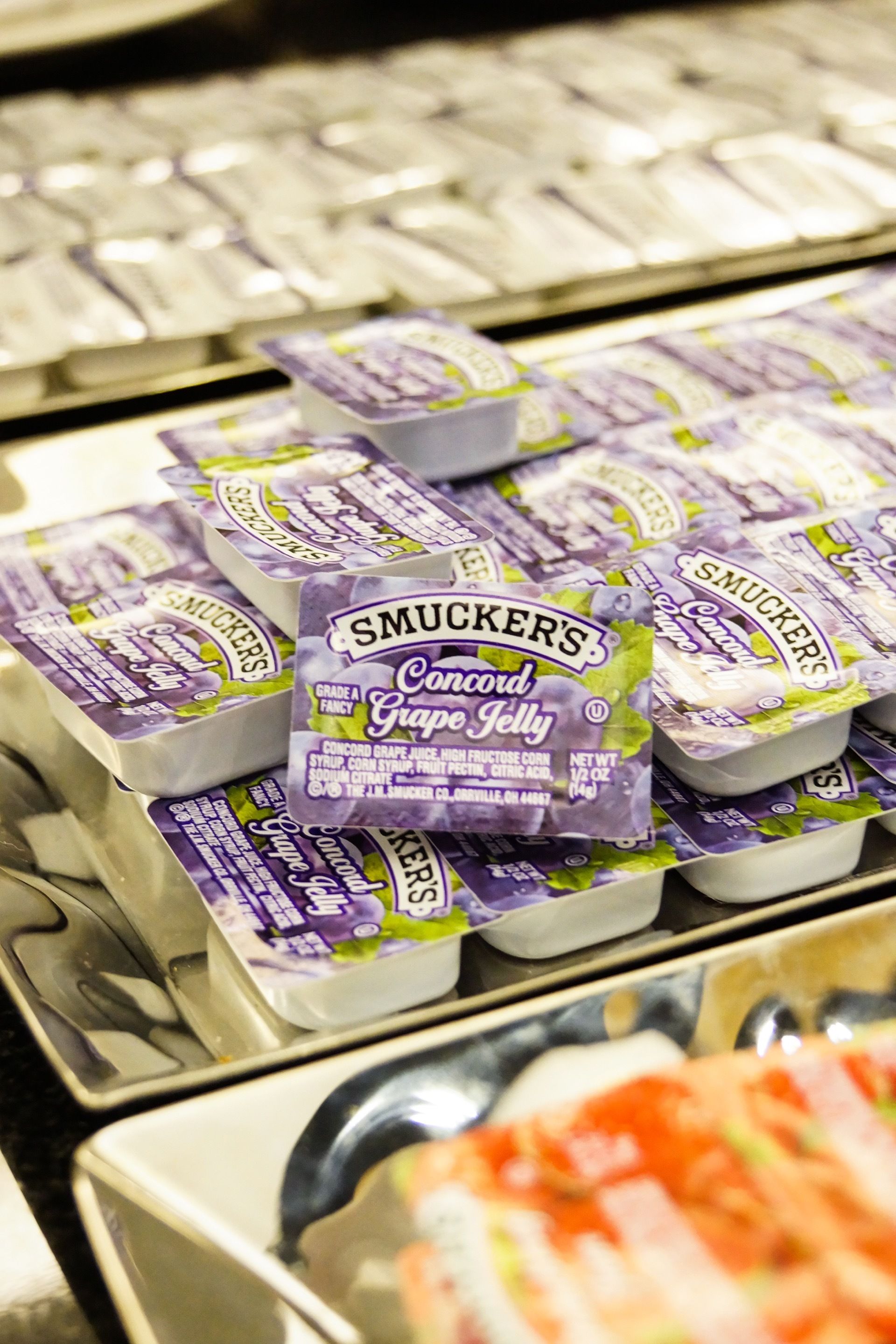 A display of Smucker's Concord Grape Jelly in a store.