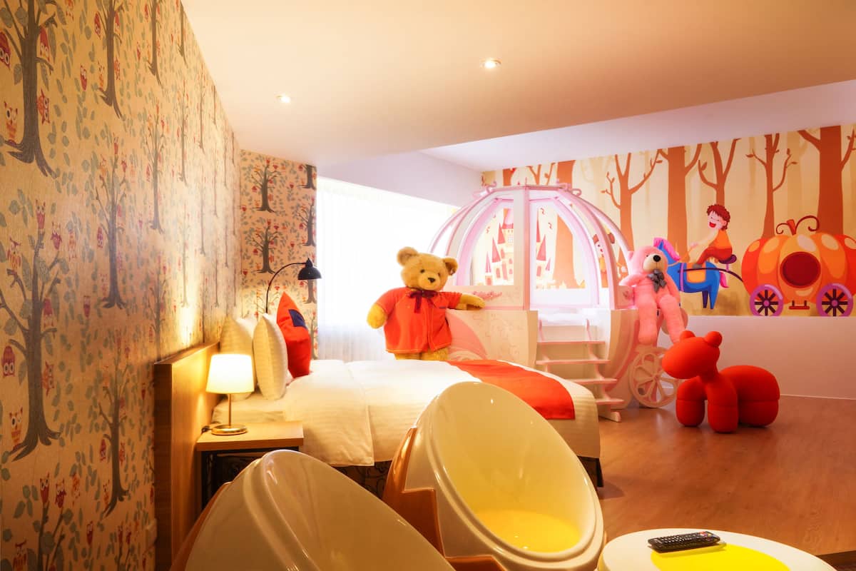 A children's room with a bed, a chair, and a teddy bear.