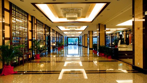A spacious, well-lit hotel lobby with a polished floor, large windows, and a modern chandelier. - Imperial Palace Hotel (Miri)