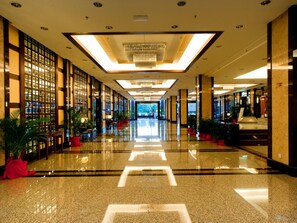 A spacious, well-lit hotel lobby with a polished floor, large windows, and a modern chandelier. - Imperial Palace Hotel (Miri)