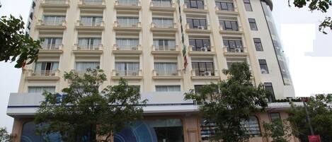 A multi-story hotel with a prominent sign reading "PALM HOTEL".