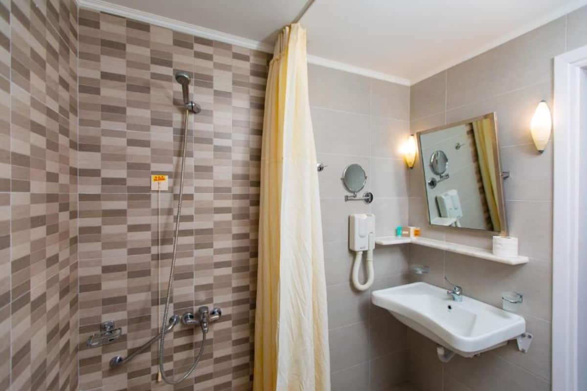 triple room pool view | bathroom | shower, free toiletries, hair dryer, bathrobes