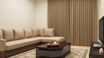 Basic Suite, 1 Bedroom | Living area | 4-inch LCD TV with satellite channels, TV