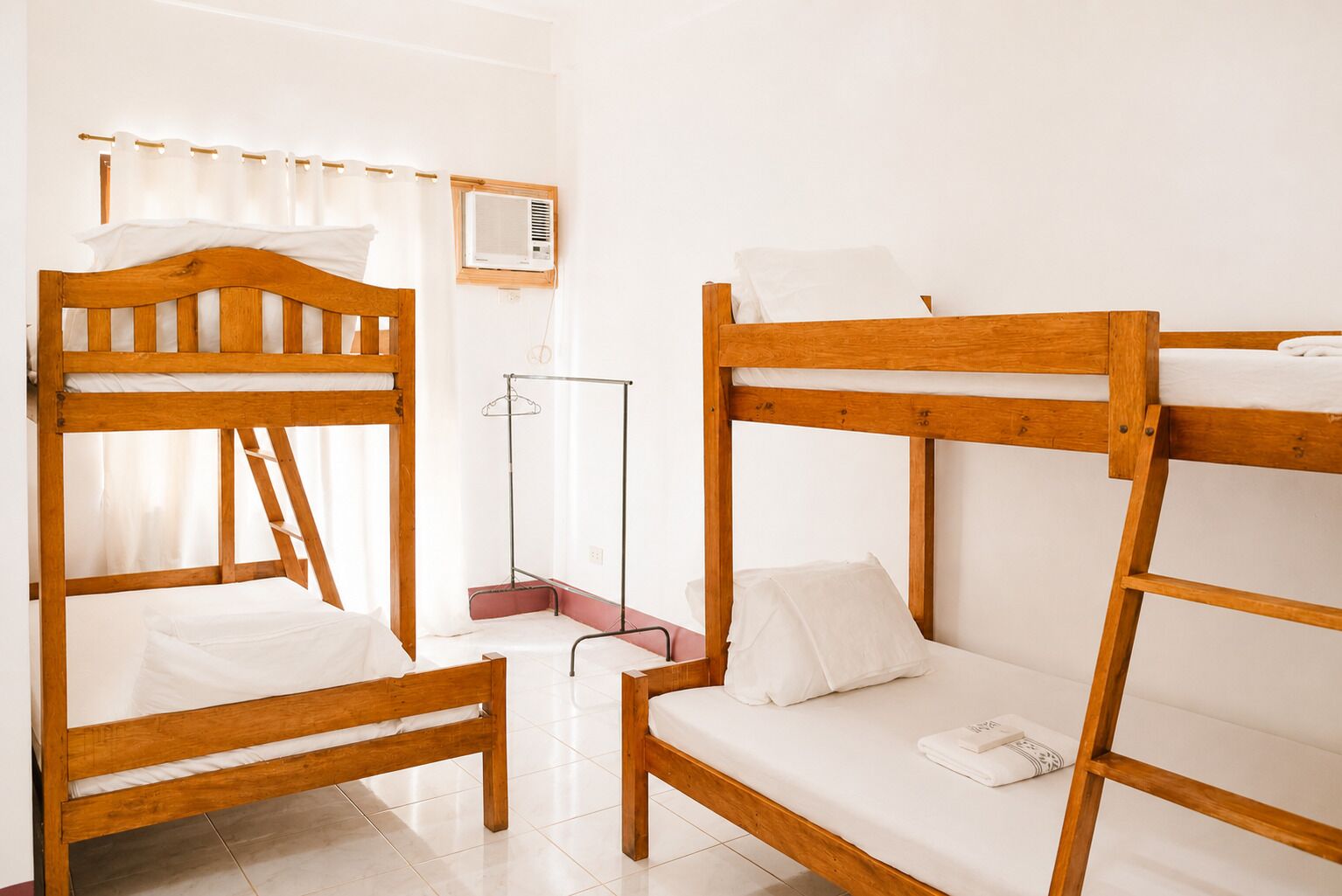 A bunk bed room with a metal rack and an air conditioning unit.