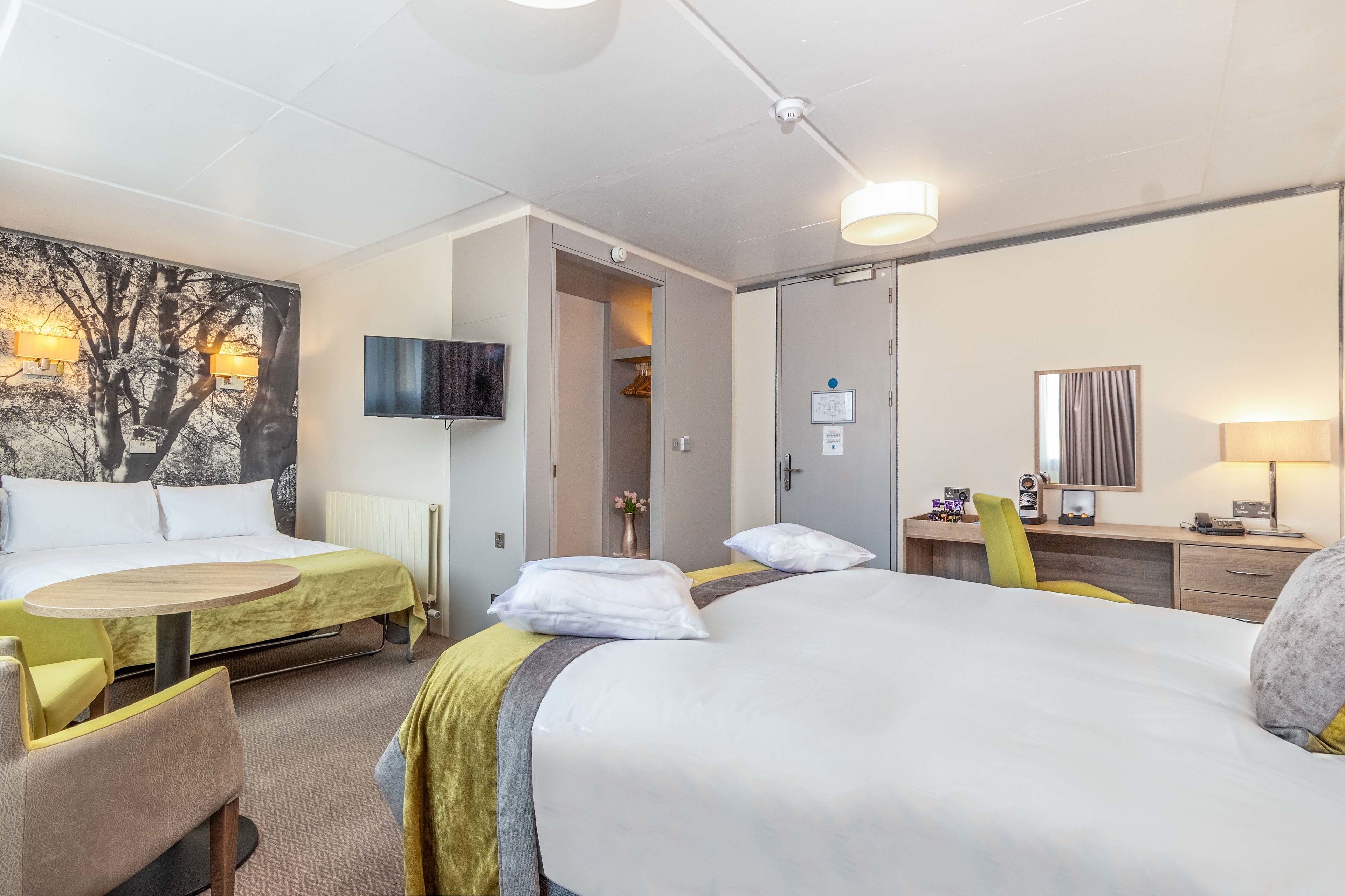 family room | desk, iron/ironing board, travel cot, bed sheets