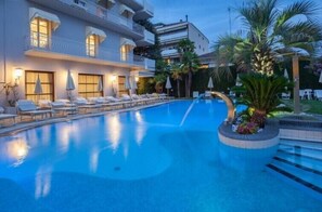 Una piscina cubierta, una piscina al aire libre, tumbonas