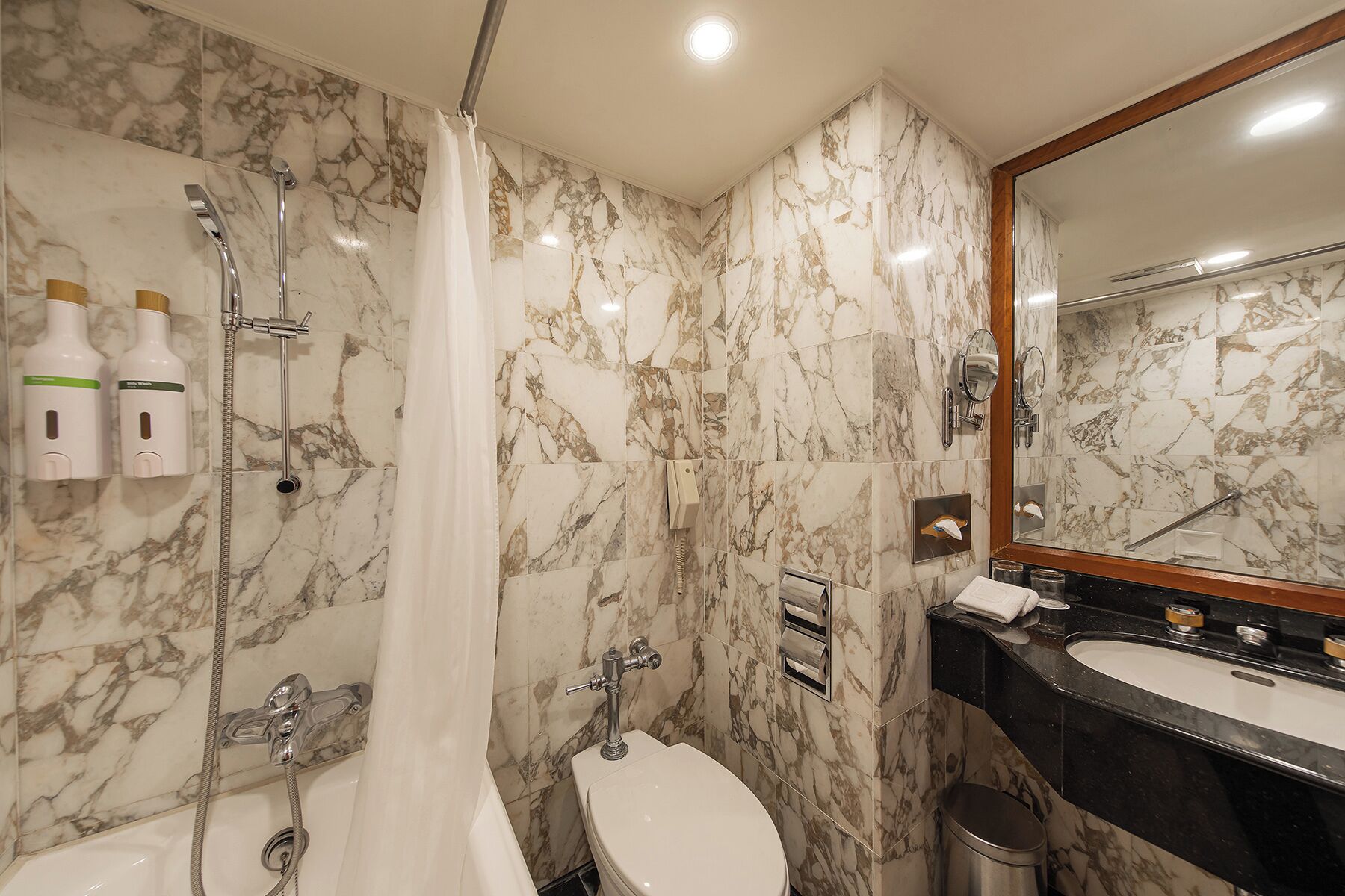 hair dryer, towels, shampoo, toilet paper