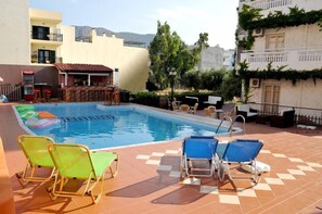 Seasonal outdoor pool, pool umbrellas, pool loungers
