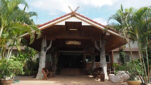 A traditional building with a tiled roof, wooden pillars, and a signboard. - Phutawan Kan Resort (Kanchanaburi)