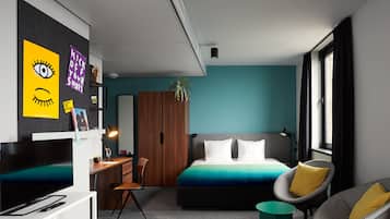 Relax in a spacious room with a large bed, comfortable armchair, and flat-screen TV.