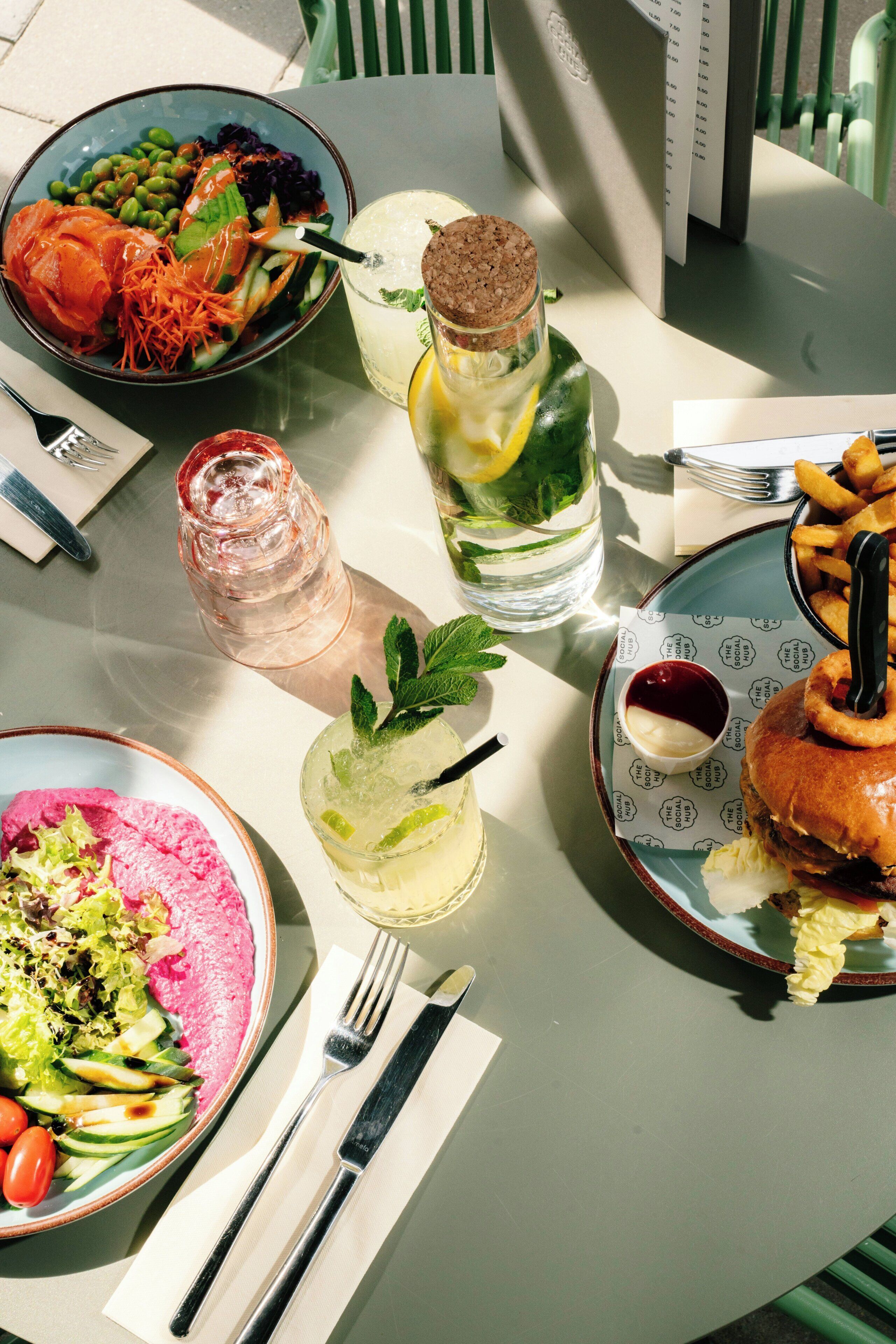 A table with various dishes, drinks, and utensils.