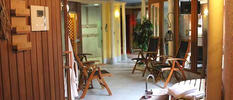 Un vestíbulo amplio con muebles de madera, una recepción y una planta grande en maceta.