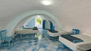 A dormitory room with two beds, a chair, and a desk. - Ring Hostel (Forio)