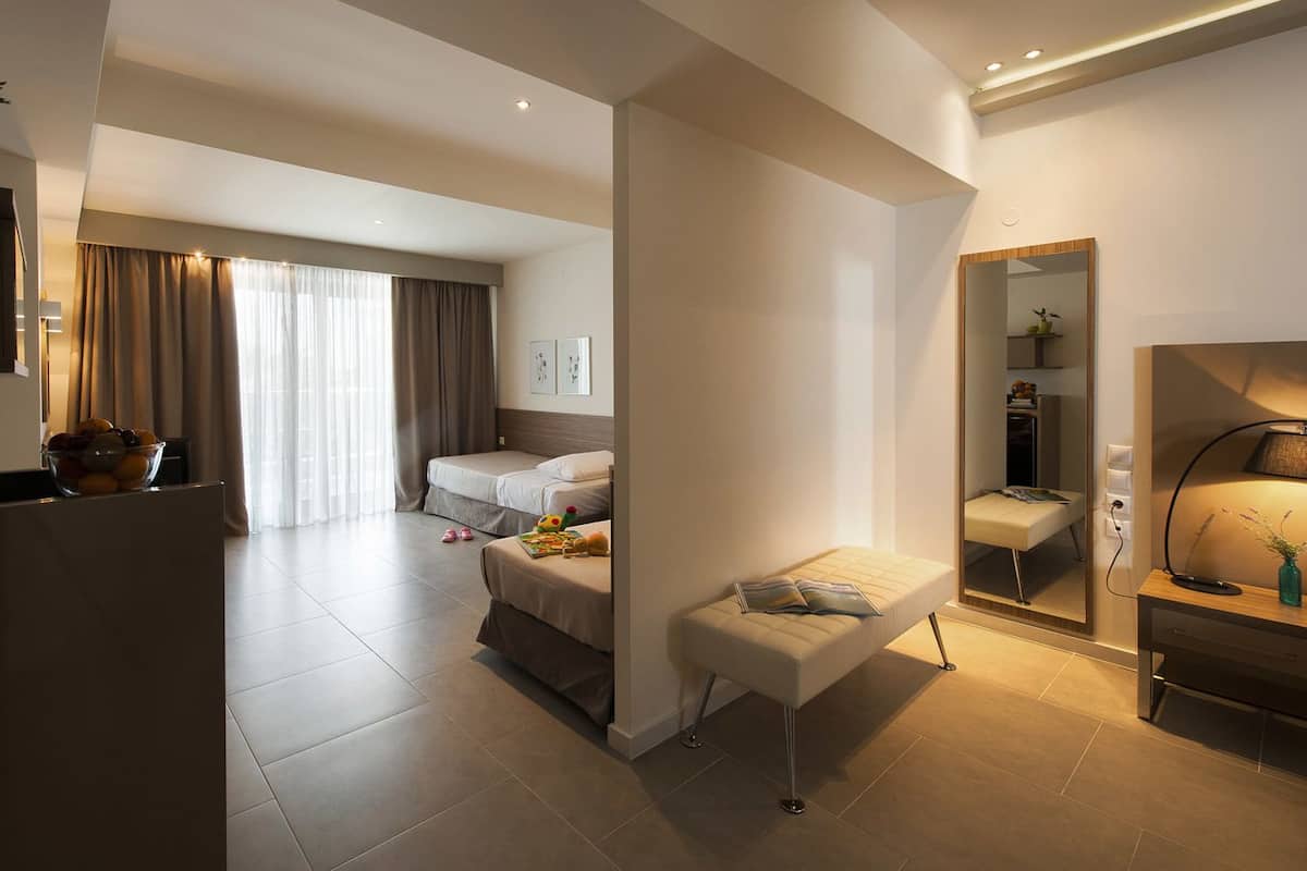 family room, partial sea view | in-room safe, desk, soundproofing, iron/ironing board