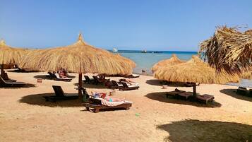 Private beach, white sand, sun loungers, beach umbrellas