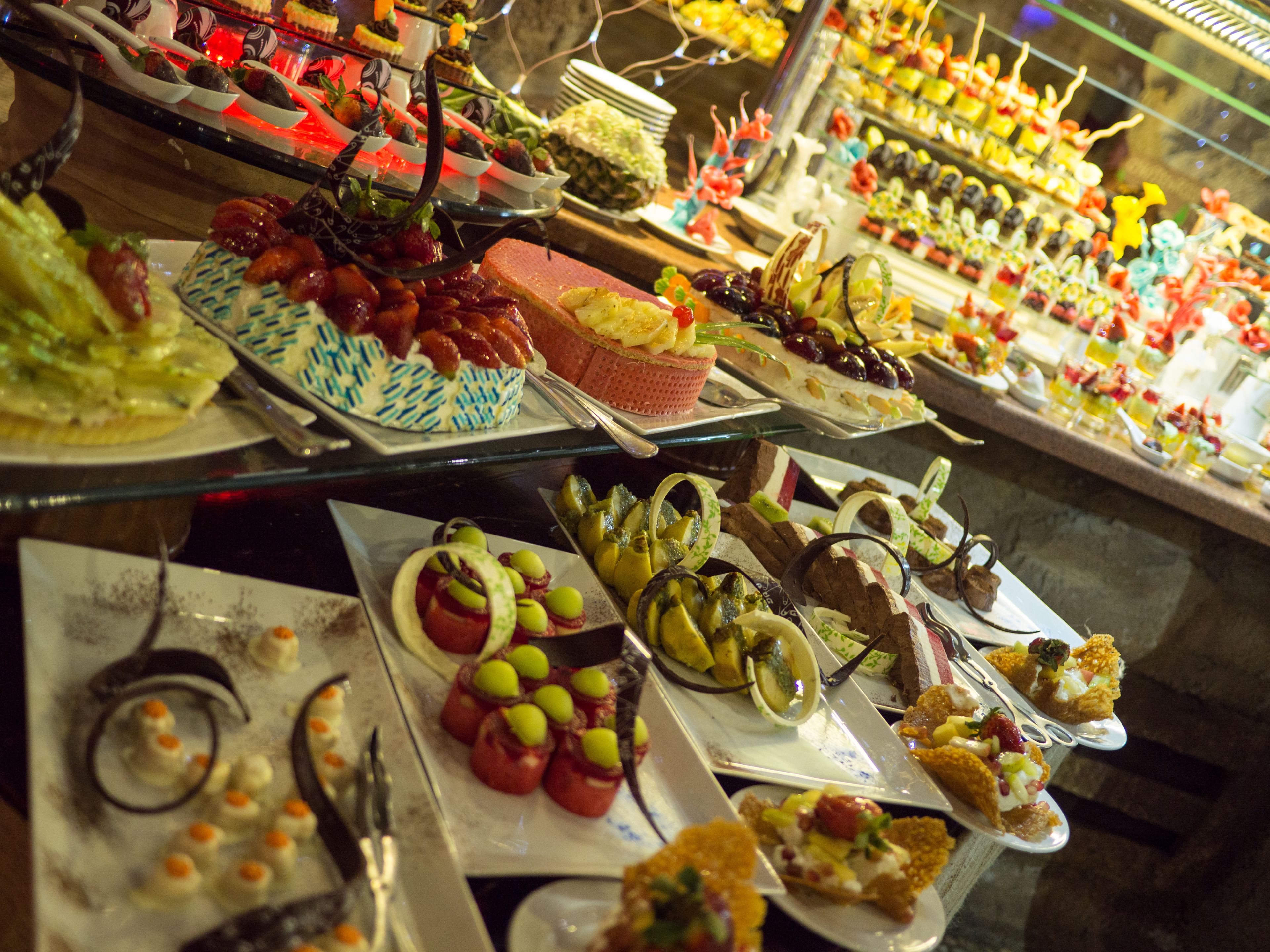 A buffet with various dishes and desserts.