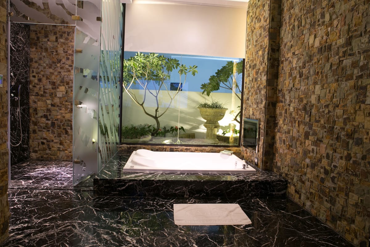 flagship suite (check in time starts from 6pm) | bathroom | separate bathtub and shower, free toiletries, hair dryer, slippers