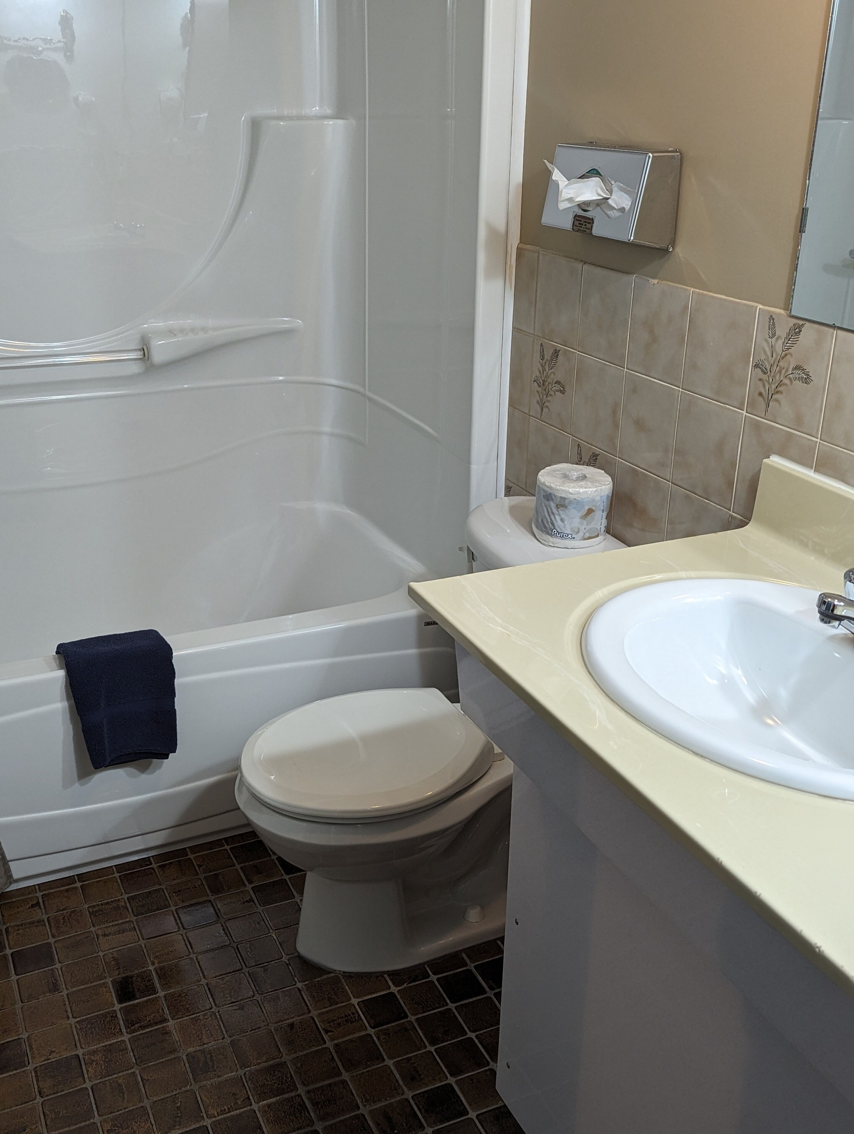 A bathroom with a bathtub, toilet, and sink.