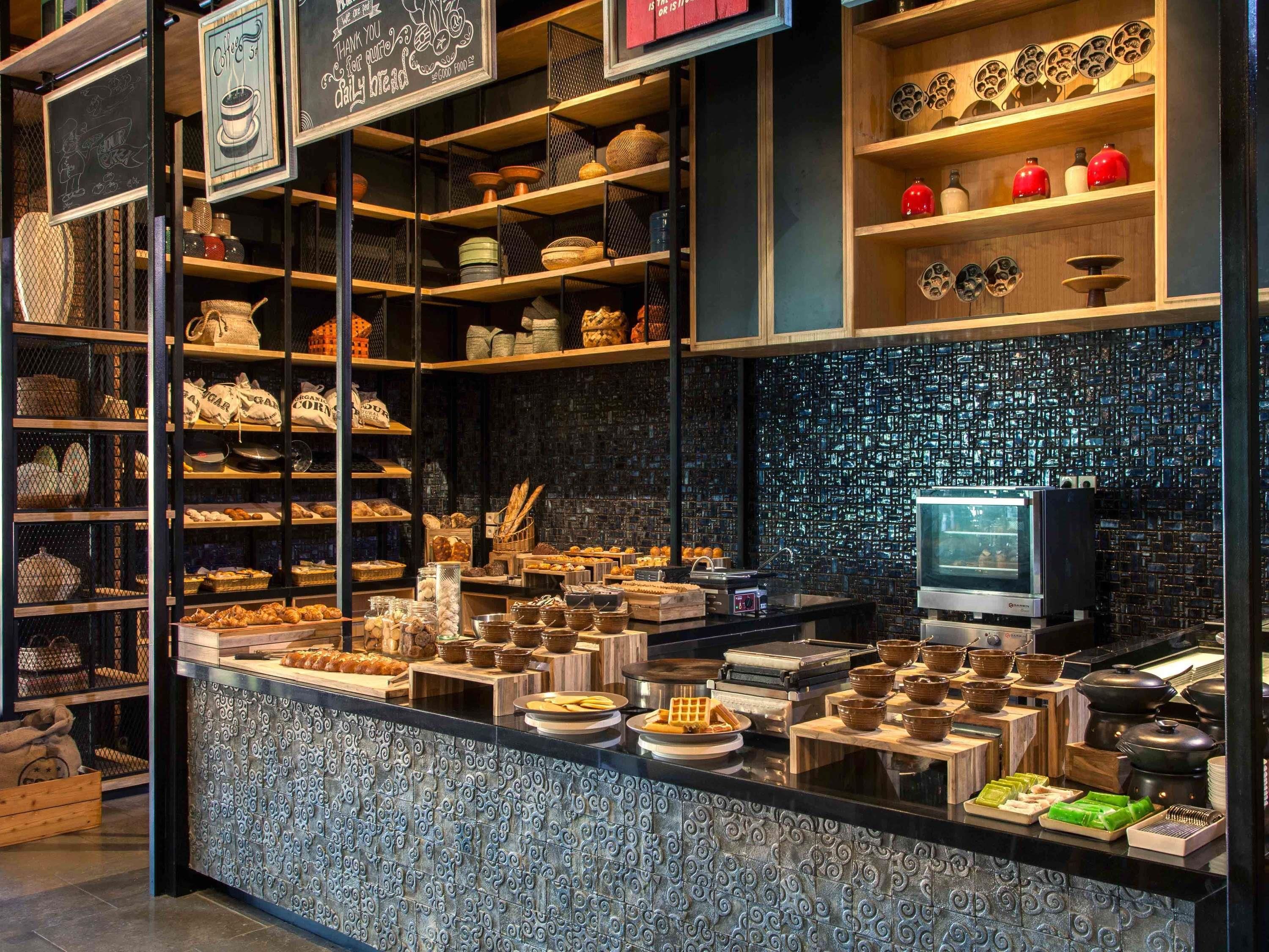 A bakery counter with various baked goods and kitchen equipment.