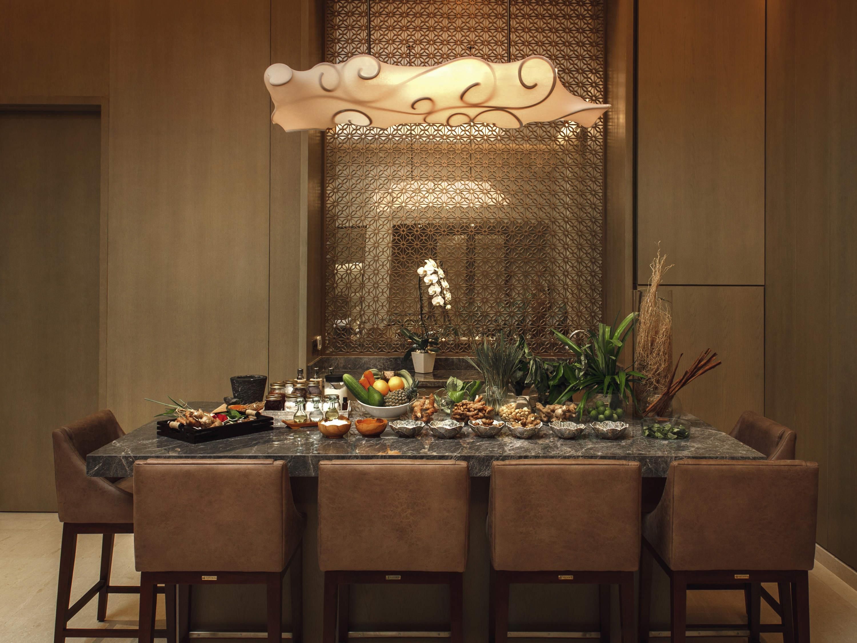 A dining table with a decorative centerpiece, surrounded by six chairs.