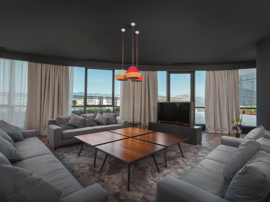 A modern living room with a sofa set, a coffee table, and a TV.