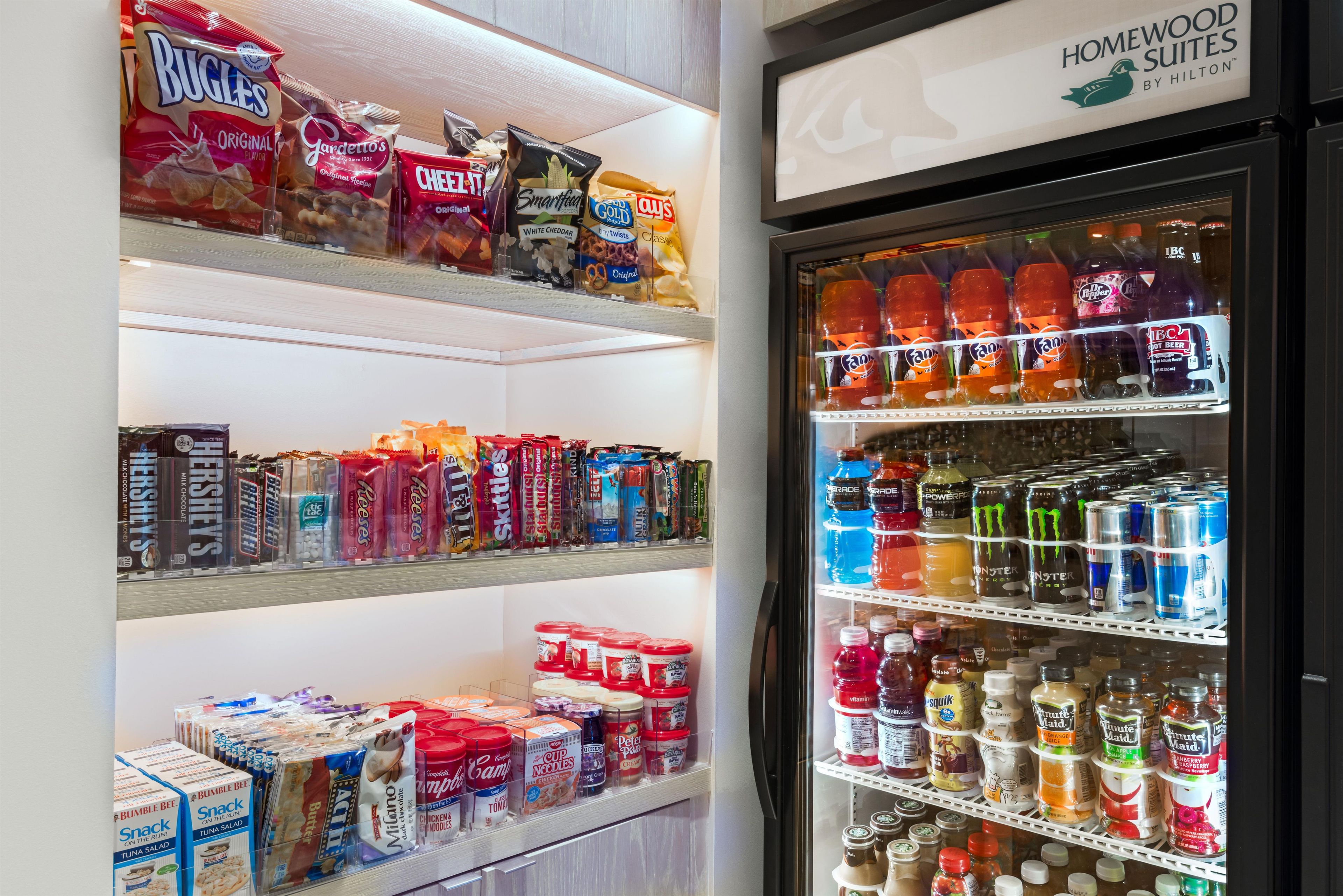 A refrigerated display with snacks, beverages, and condiments.