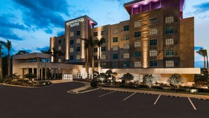 A modern hotel with a prominent "Homewood Suites" sign, multiple floors, and a well-lit entrance area with parking. - Homewood Suites by Hilton Sarasota Lakewood Ranch (Sarasota)