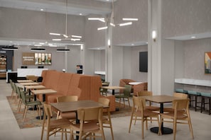 A modern hotel lobby with a reception desk, seating areas, and a cityscape artwork. - Hampton Inn & Suites Charlotte/Ballantyne (Charlotte)