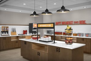 A breakfast station with a sign that reads 'HAPPY BREAKFAST STARTS HERE.' - Hampton Inn & Suites Charlotte/Ballantyne (Charlotte)