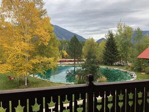 A view of a mountain landscape with a pond and trees. - Great Northern Resort (West Glacier)