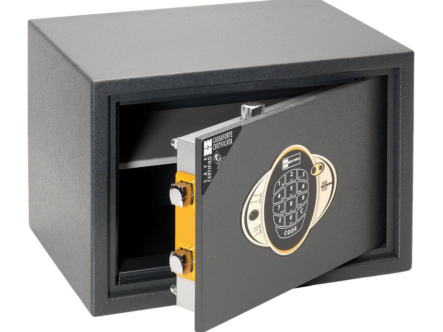 A safe with a combination dial and a metallic keyhole.