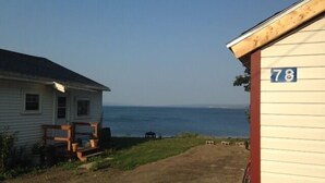 A coastal property with a house and a small building marked with the number 78. - Beautiful Seaside Cottage (Digby)