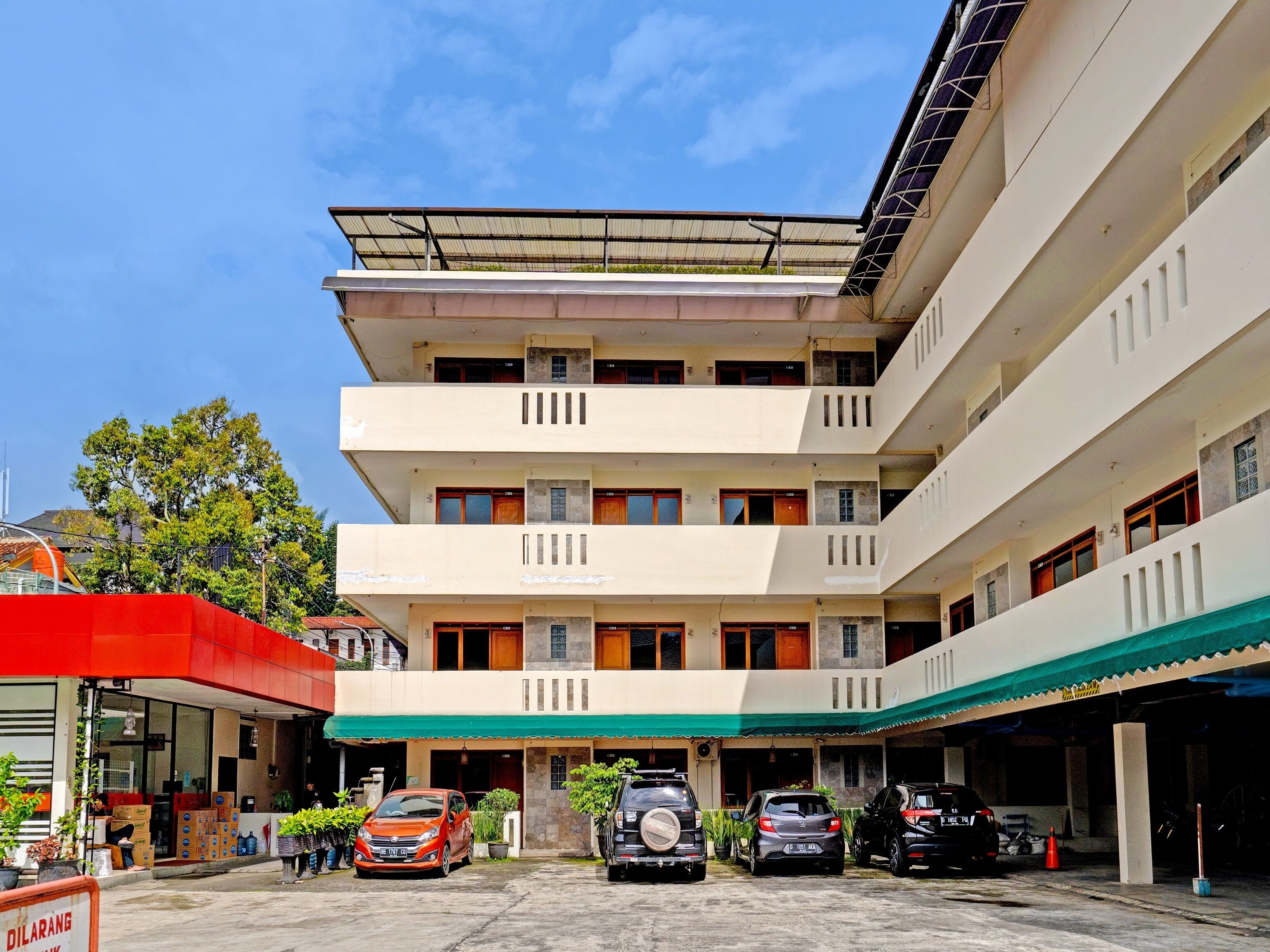 A multi-story building with a covered parking area.