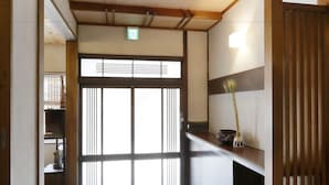 A traditional Japanese interior with sliding doors, a wooden floor, and a basket of items. - NARA Guesthouse KAMUNABI - Hostel (Nara)