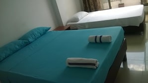 A hotel room with two beds, each with a teal bedspread and white pillows. - Hotel Zafiro Real (Anapoima)