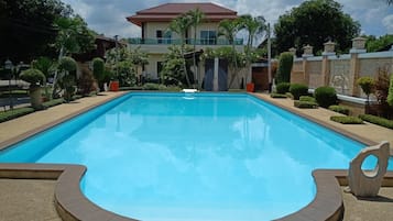 Una piscina al aire libre, sombrillas, tumbonas