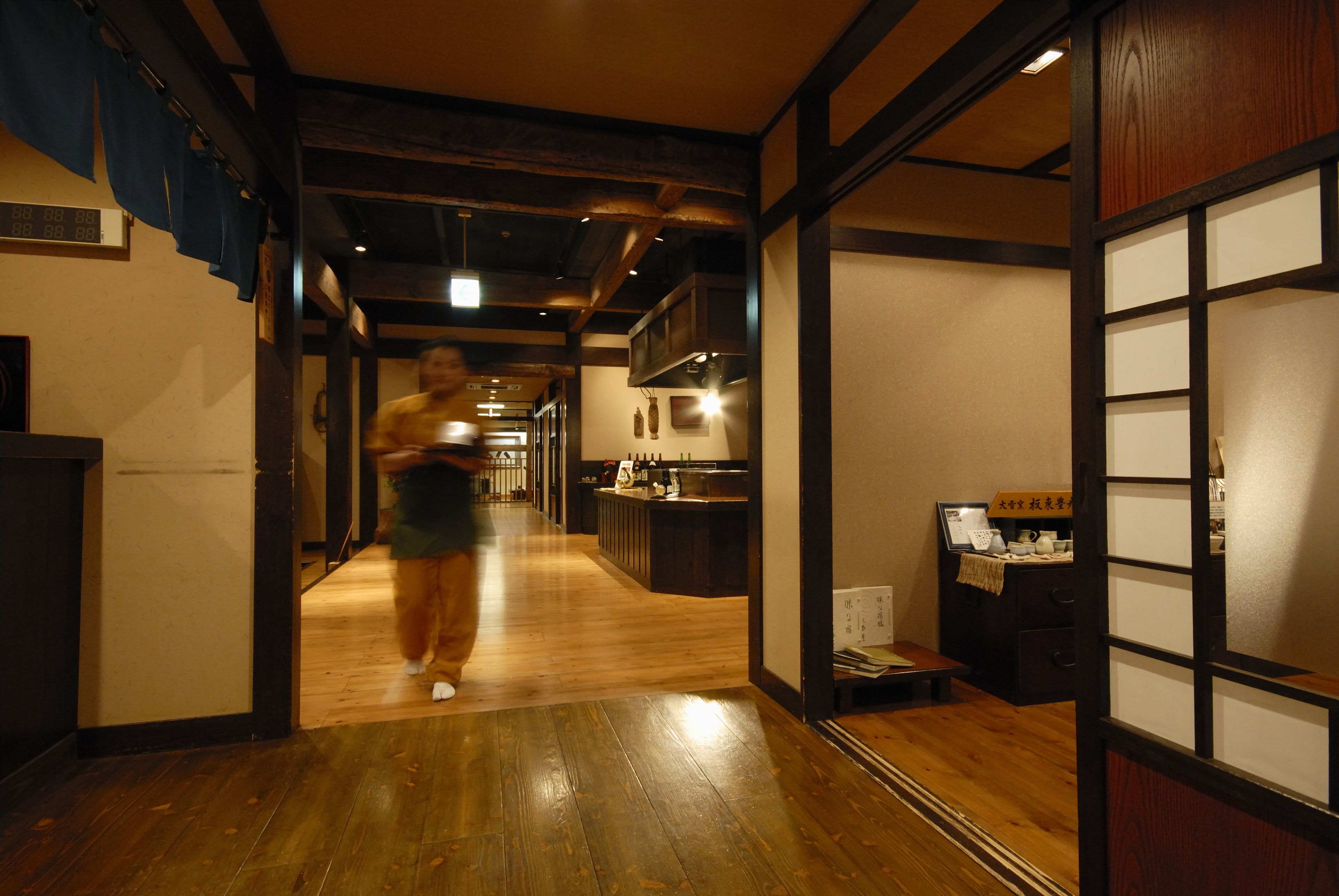 A hallway with wooden flooring and traditional Japanese sliding doors.