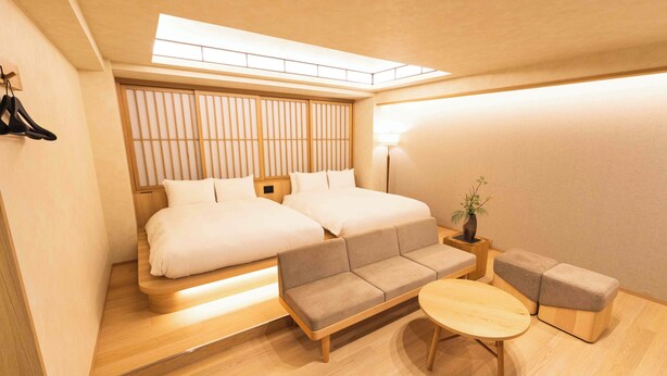 A modern hotel room with a bed, sofa, and a small table. - HOTEL PAUL HOUSE (Tokyo)