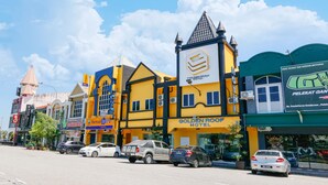 A hotel with a yellow facade, a pointed roof, and a sign for the Golden Roof Hotel. - Golden Roof Hotel Sunway Ipoh (Ipoh)